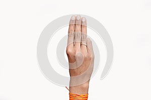 A 15 years old young hand with three fingers salute symbol