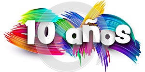 10 years at spanish paper word sign with colorful spectrum paint brush strokes over white photo