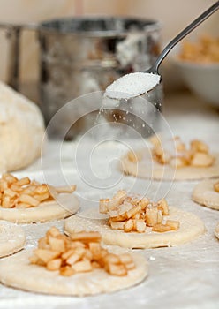 Yeast dough with flour. Making apple pies.