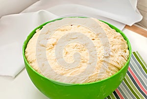 Yeast dough rises in a bowl