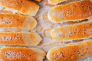 Yeast hot dog buns sprinkled with sesame seeds right from the oven