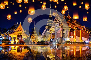 Yee peng festival and sky lanterns at Wat Phra Singh temple at night in Chiang mai, Thailand. photo