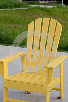 Yellow Adirondack chair at the beach