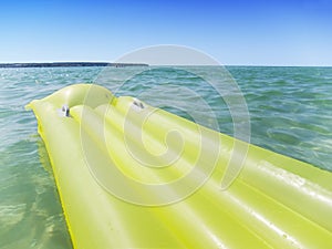 Yellow airbed in the sea photo