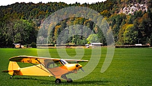 Yellow airplain on the green grass photo