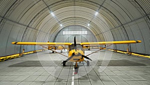 Yellow airplane glider in the hangar.