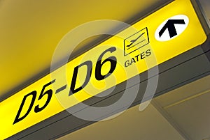 Yellow airport direction departure sign