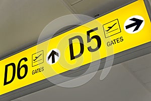 Yellow airport direction departure sign