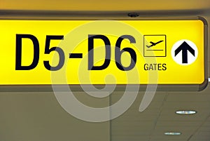 Yellow airport direction departure sign