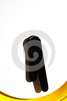 Yellow alarm clock isolated on a balck background. Close-up