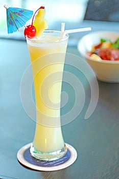 Yellow alcohol cocktail with pineapple