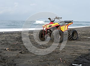 A yellow all-terrain vehicle (ATV), in Parangtritis Beach, Yogyakarta, Indonesia