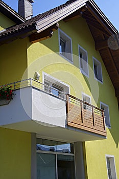 Yellow alpine hotel in the village of Toblach photo