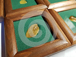 Yellow amber inserted into a wooden frame