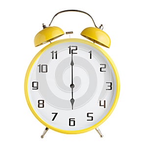 Yellow analog alarm clock showing six o`clock isolated on white background