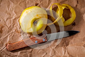 Yellow apple reinetas semi peeled with knife. photo