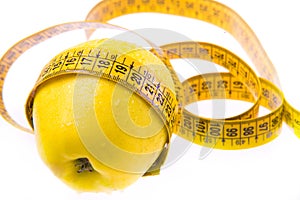 Yellow apple and ruler