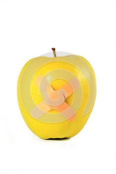 Yellow apple with strapping tape isolated