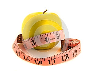 Yellow apple with tape measure