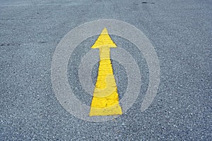 A yellow arrow on the road, conceptual image of business direction