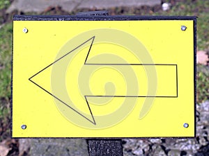 Yellow arrow sign pointing this way left