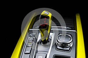 Yellow Automatic gear stick of a modern car. Modern car interior details. Close up view. Car detailing. Automatic transmission lev