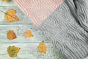 Yellow autumn leaves on an old textured wooden background with a textured jacket