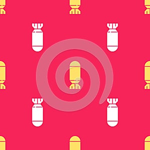 Yellow Aviation bomb icon isolated seamless pattern on red background. Rocket bomb flies down. Vector