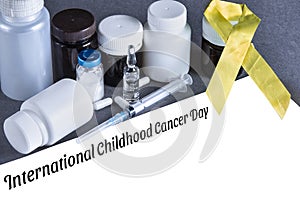 Yellow awareness ribbon, sheet of paper, pills and drugs. Lettering International Childhood Cancer Day. Mockup