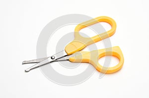 Yellow baby scissors on a white background