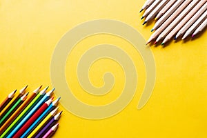 Yellow background with colorful pencils in the corners