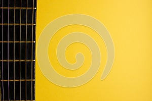 Yellow background. Guitar. Guitar strings, neck. Poster