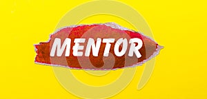 On a yellow background, a sheet of red paper with the word MENTOR