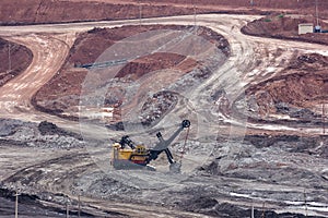 yellow backhoe work in coalmine