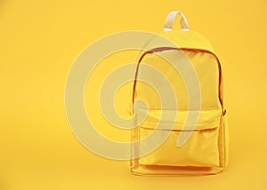 Yellow backpack empty space background,travel concept.Rucksack education symbol.Back to school