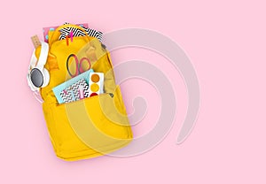 Yellow backpack with school supplies isolated on pink background