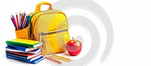 Yellow backpack with stationery, apple and books isolated on white background