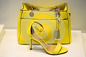 Yellow bag with a greenish tint in combination shoes the same colors. The concept of style and taste