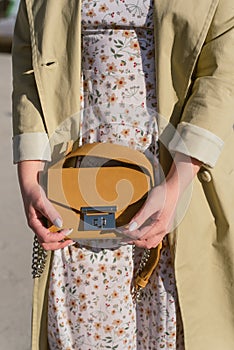 Yellow bag in the hand of a girl in the sun.