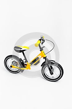 Yellow balance bike on white background
