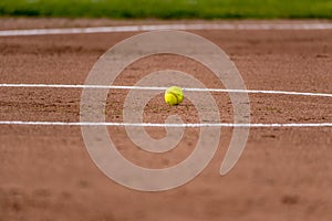 Yellow ball on the clay infield