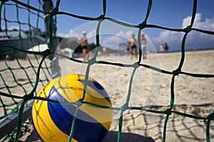 Yellow ball in the goal on the beach