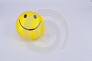 Yellow ball smiley on white background