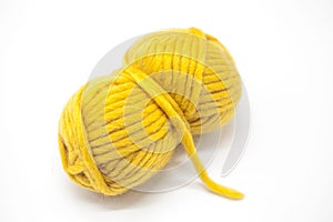 Yellow ball of wool yarn for knitting close up on a white background.