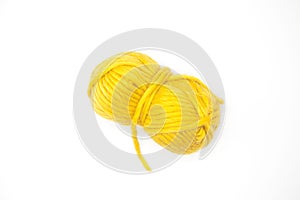 Yellow ball of wool yarn for knitting close up on a white background.