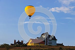 Yellow balloon in blue sky