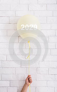 Yellow balloon with white concept text in woman hand