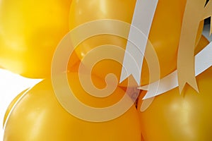 Yellow balloon and yellow and white ribbon