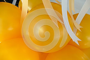 Yellow balloon and yellow and white ribbon