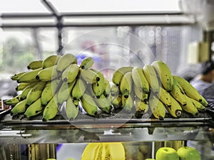 Yellow banana on the back of clear glass cabinet photo